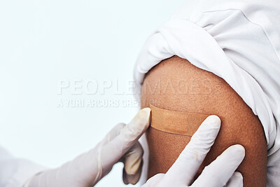 Buy stock photo Healthcare, arm and closeup with plaster for vaccine, hands of doctor for protection and virus safety in clinic. Consultation, patient and medical professional in hospital for vaccination medicine.