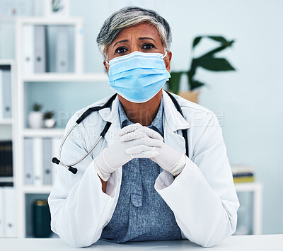Buy stock photo Healthcare, face mask and portrait of a female doctor in her office in the hospital for disease diagnosis. Gloves, concern and professional senior woman medical worker with virus prevention in clinic