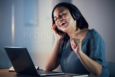 Buy stock photo Happy woman, headphones and listening to music at night for online audio streaming on office desk. Female person or employee working late and enjoying sound track or songs on headset at the workplace