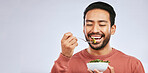 Fruit, healthy food and happy asian man in studio for health, wellness or detox on grey background. Breakfast, salad and face of guy nutritionist smile for clean, green or raw diet or vegan lifestyle