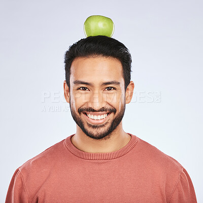 Buy stock photo Portrait, apple head balance and man smile for weight loss diet, healthy snack or body nutrition vitamins. Eating food, nutritionist fruit and studio face of hungry Asian person on white background