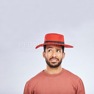Buy stock photo Fashion, hat and mockup with a confused man in studio isolated on a gray background in doubt about his style. Question, mistake and frown with a young asian male model in trendy red headwear