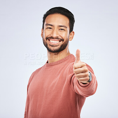 Buy stock photo Thumbs up, portrait and happy asian man in studio, white background and thank you. Male model, thumb emoji and smile of winner, achievement and celebration of feedback, good review and yes with hands