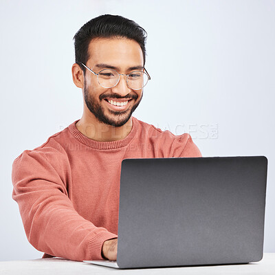Buy stock photo Laptop, IT and man with glasses in studio, white background and programming digital code. Happy asian male model, software developer and computer engineer typing on technology for coding website data