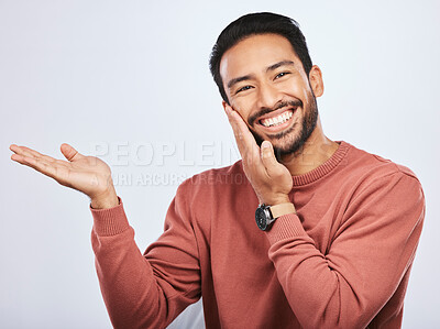 Buy stock photo Hand pointing, smile and portrait of asian man in studio with mockup, promotion or news on a white background. Happy, face and male person with platform for menu, open palm or sale announcement 