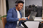 Black man with a podcast, laptop and microphone with headphones for audio, technology or listening to sound in office. Talking, radio and presenter of live streaming show, broadcast or discussion