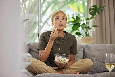 Buy stock photo Surprise, watching tv and a woman on the sofa with popcorn for a movie or show. Wow, house and a young girl eating a snack while on the living room couch for a horror, film or streaming a drama