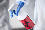 Hazmat suit, spray bottle and gloves for biohazard, covid and stop virus for safety, protection or test in laboratory. Person, science and cleaning with chemical, liquid and ppe for bacteria in room