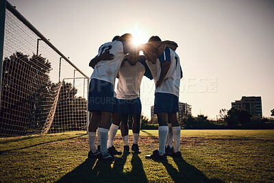 Buy stock photo Soccer, sunset or team in a huddle for motivation, goals or group mission on stadium field for a sports game. Match, sunshine or football players planning a strategy, exercise or training for fitness