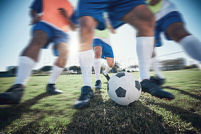 Buy stock photo Football player, feet and men with a ball together on a field for sports game or fitness. Blurred closeup of male soccer team or athlete group for tackle challenge, action or training workout outdoor