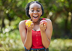 Happy black woman, lemon and apple in surprise for vitamin C, natural nutrition or diet in nature. African female person with citrus and organic fruit for healthy eating, fiber and wellness outdoors