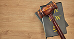 Background, law books and gavel on table at mockup space of judge, justice or lawyer in courtroom. Overhead, hammer and research knowledge of legal system, constitution and truth, litigation or trial