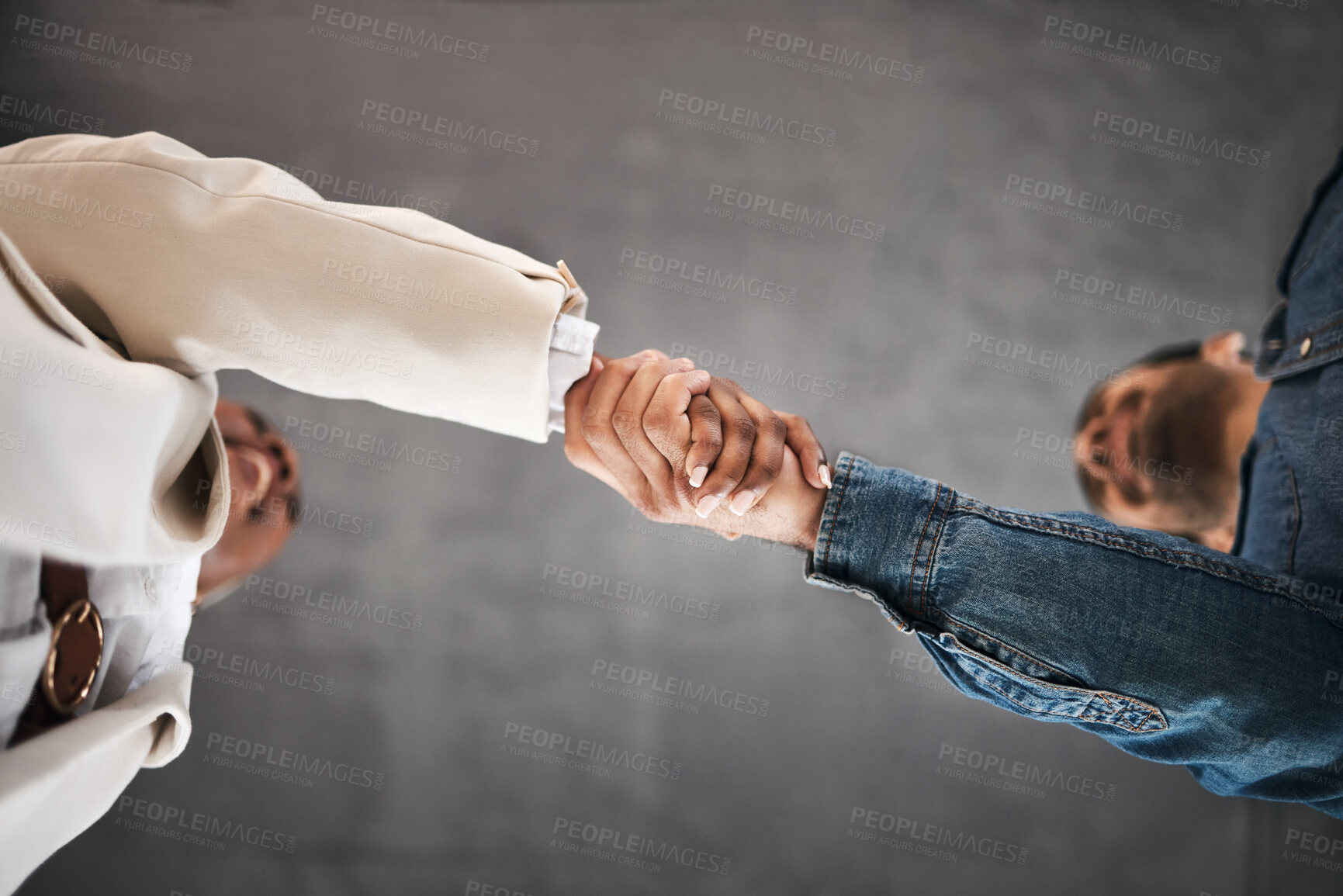 Buy stock photo Business people, handshake and meeting in partnership, teamwork or trust for unity below at office. Low angle of employees shaking hands for introduction or greeting in agreement or deal at workplace