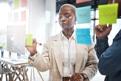 Buy stock photo Black woman, writing and schedule planning in meeting for brainstorming, teamwork or tasks at office. African female person or employee working on team strategy, ideas or business agenda at workplace