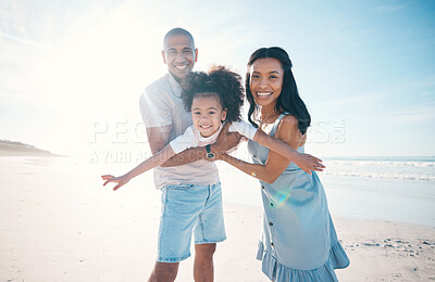 Buy stock photo Beach, portrait and parents holding their child on the sand by the ocean on a family vacation. Happy, smile and girl kid flying and bonding with her young mother and father on tropical summer holiday