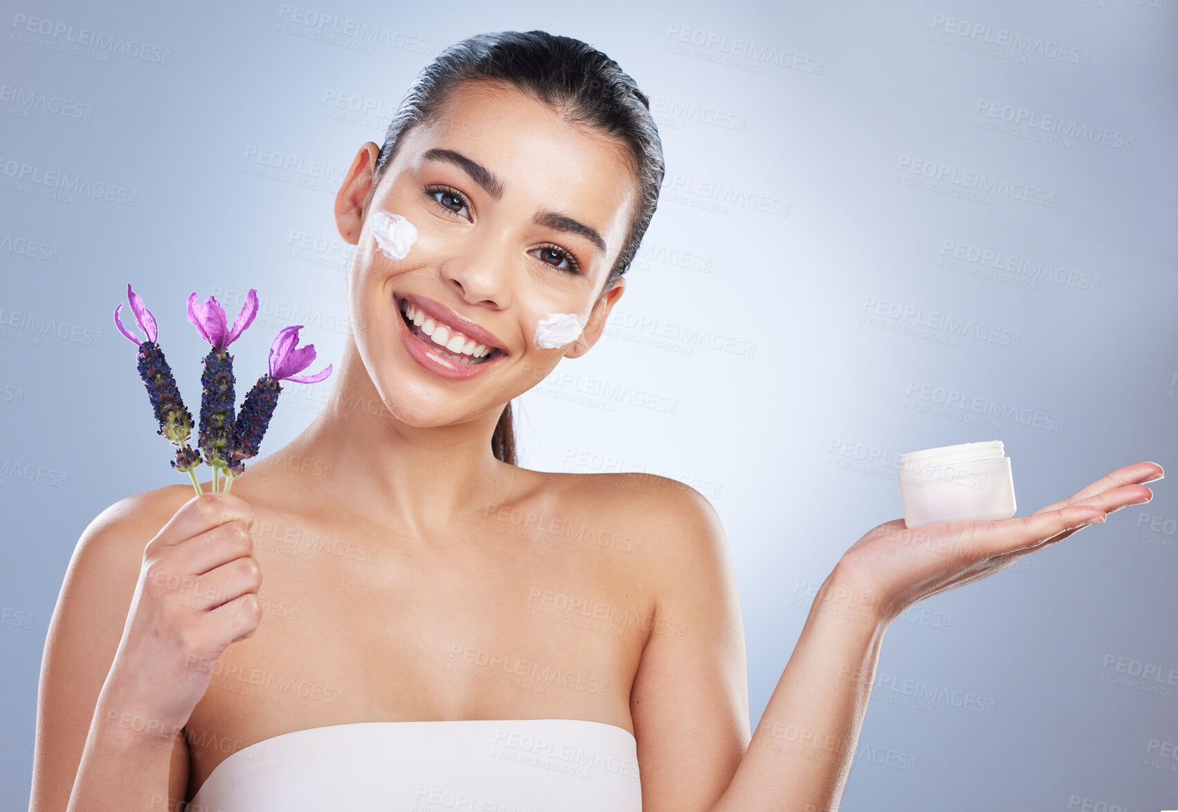 Buy stock photo Beauty, cream and woman with lavender flower in studio for skincare product and natural glow. Portrait of happy female model on a gradient background for facial shine, cosmetics and face moisturizer