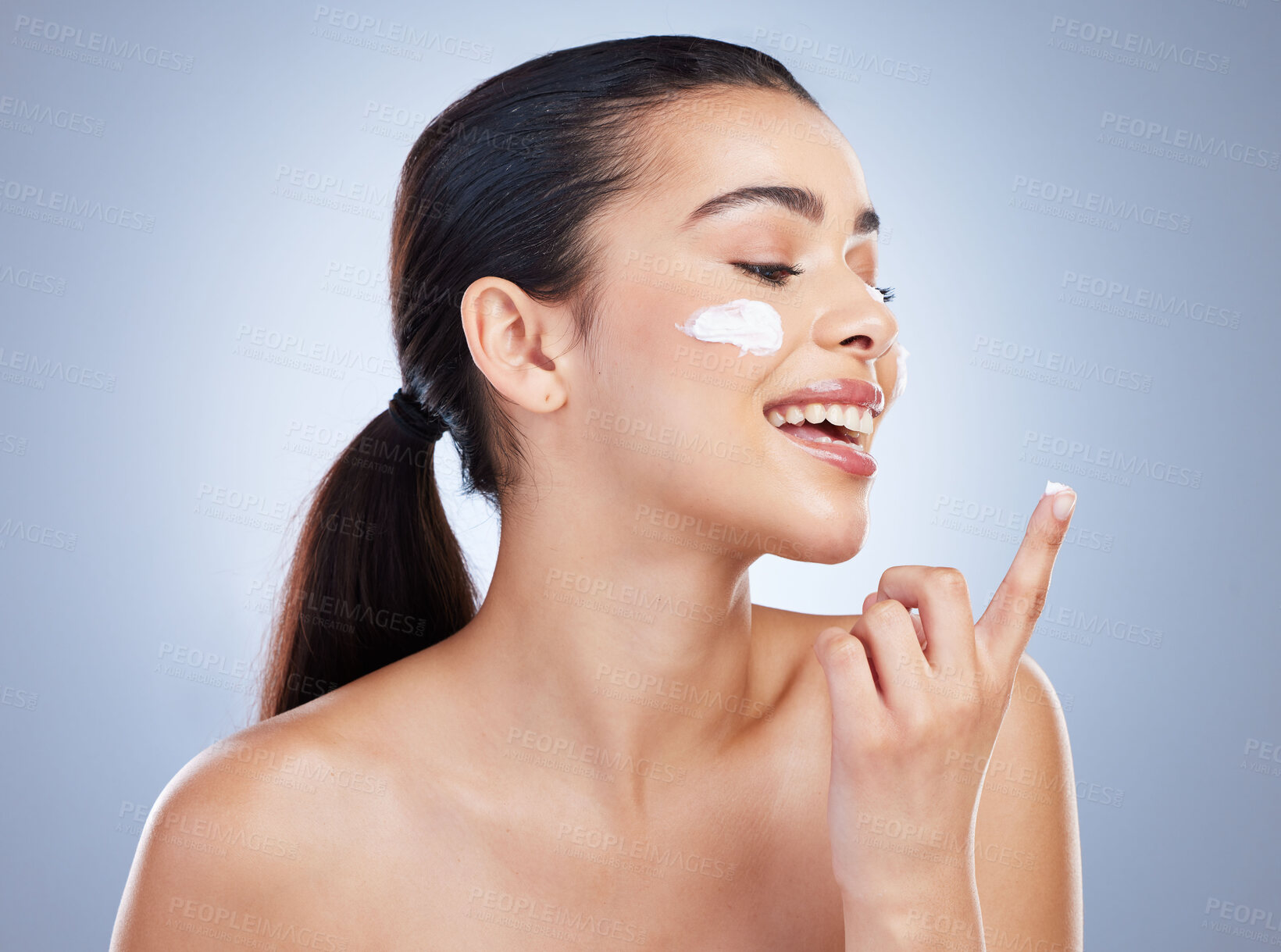 Buy stock photo Skincare, hand and happy woman with face cream in studio or anti aging, collagen or hydration on grey background. Finger, smile and lady model with facial sunscreen, lotion or beauty mask application