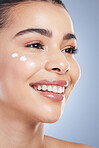 Skincare, beauty and happy woman with face cream application in studio for beauty, wellness or care on grey background. Sunscreen, smile and asian female model relax with luxury hydration facial mask