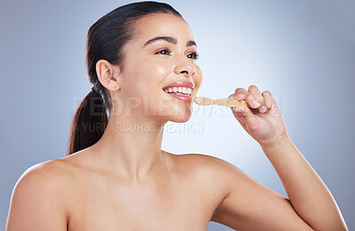 Buy stock photo Woman, wood toothbrush and studio for cleaning mouth, healthy smile or eco friendly cosmetics by background. Girl, model and sustainability for dental self care, teeth whitening and happy with vision