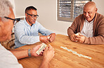 Senior men, friends and table for domino game, contest and happy together with strategy in retirement. People, elderly group and relax with focus, competition and mindset for winning, fun and house