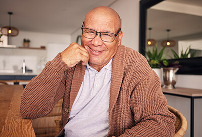 Buy stock photo Portrait, smile and glasses with a senior man sitting in the living room of his home during old age retirement. Relax, wrinkles and satisfaction with a happy elderly male pensioner in his house