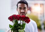 Love, giving and man with bouquet of roses for date, romance and hope for valentines day. Confession, romantic gift and person holding flowers outside, proposal or engagement on blurred background.