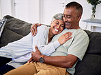 Hug, marriage and senior woman or man on sofa with love or care in family home to relax. Retirement, smile and elder couple with embrace in living room for bonding together or quality time in house.