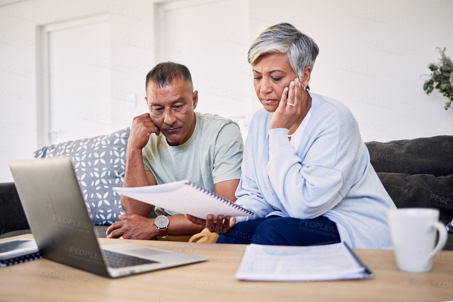 Buy stock photo Senior couple, tax documents and stress with laptop in living room for planning, thinking and budget. Elderly man, woman and paperwork for financial compliance, anxiety or debt in retirement on sofa