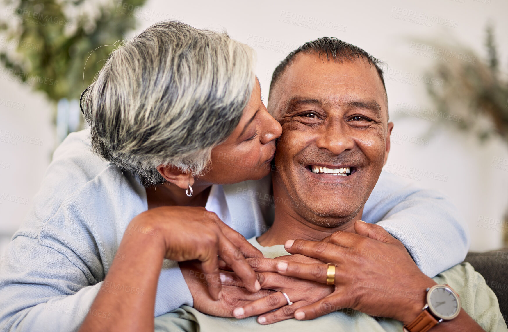 Buy stock photo Love portrait, kiss and happy elderly couple bond, relax and enjoy time together, smile and retirement wellness. Home apartment, sofa and face of elderly man, woman or people with marriage happiness