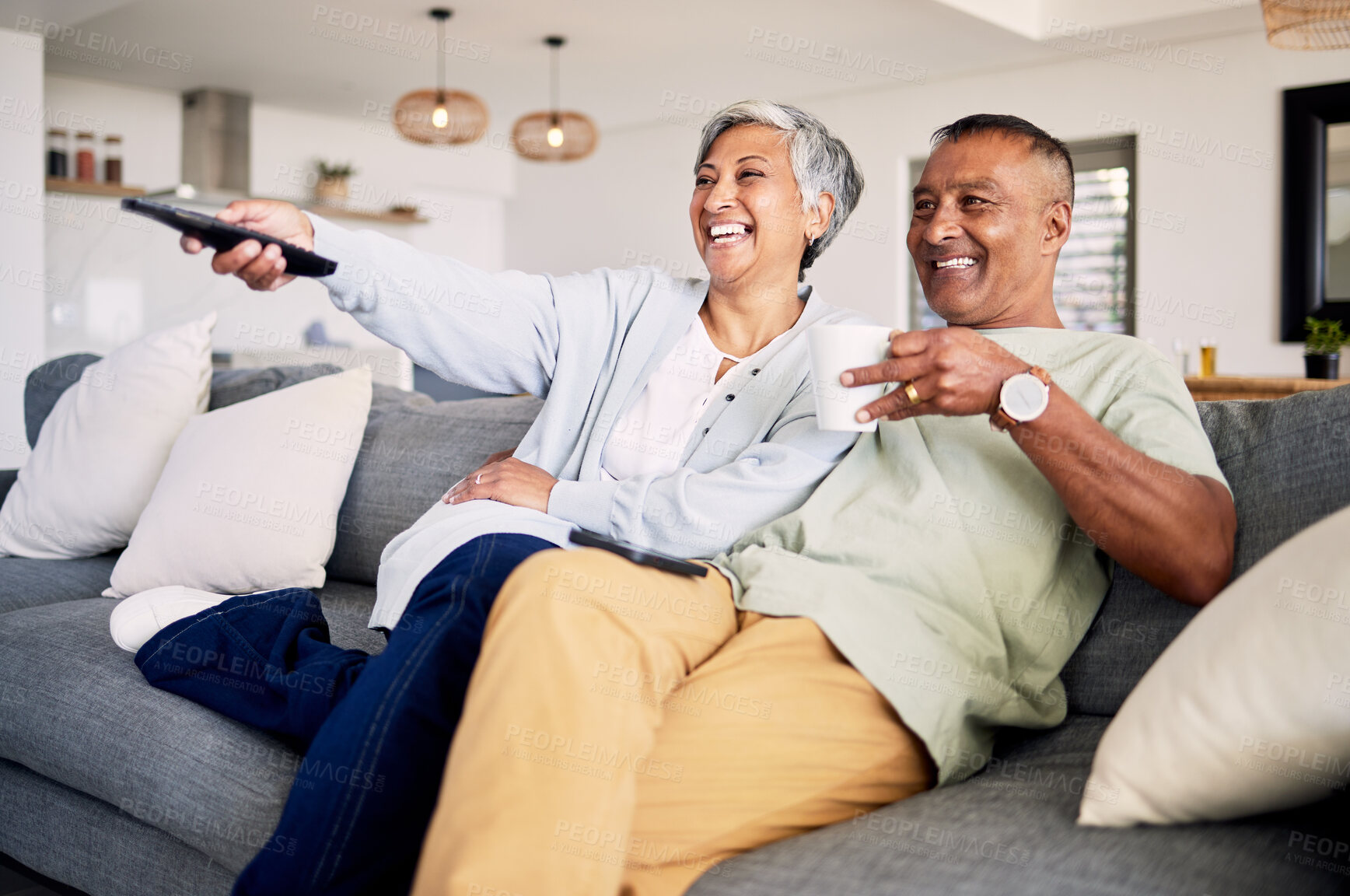 Buy stock photo Senior couple, watching tv and relax on sofa in home living room, laughing and together for funny comedy show. Elderly man, old woman and happy for streaming comic movie on lounge couch in house