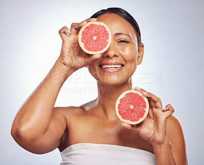 Buy stock photo Face, happy and senior woman with grapefruit in studio isolated on a white background. Skincare, natural fruit and portrait of model with food for nutrition, healthy diet and vitamin c for anti aging