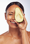 Face, skincare and senior woman with avocado in studio isolated on a white background. Happy, natural fruit or portrait of mature model with food for nutrition, healthy diet or omega 3 for anti aging