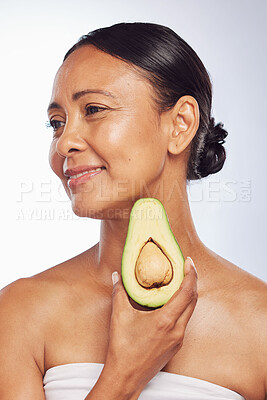 Buy stock photo Avocado, skincare or happy mature woman with fruit for cleaning, detox or healthy skin with beauty. Wellness, white background or senior model smiling for natural dermatology treatment in studio 