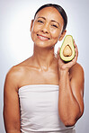 Skincare, portrait and senior woman with avocado in studio isolated on a white background. Face, natural fruit and happy model with food for organic nutrition, healthy diet and omega 3 for anti aging