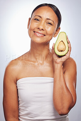 Buy stock photo Skincare, portrait and senior woman with avocado in studio isolated on a white background. Face, natural fruit and happy model with food for organic nutrition, healthy diet and omega 3 for anti aging