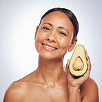 Face, skincare and senior woman with avocado in studio isolated on a white background. Portrait, natural fruit and happy model with food for organic nutrition, healthy diet and omega 3 for anti aging