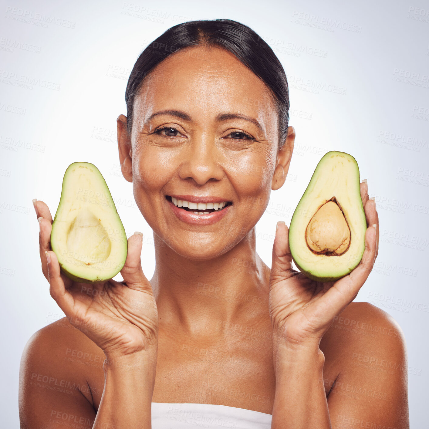 Buy stock photo Avocado, portrait and beauty of woman in studio, white background and face glow. Happy mature model, natural skincare and fruits for sustainable cosmetics, vegan dermatology and facial benefits