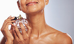 Woman, spray and perfume for beauty in studio, white background or aesthetic product of fresh scent. Closeup of happy female model with fragrance cosmetics, parfum application and bottle of cologne