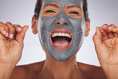 Buy stock photo Portrait, face mask and a woman flossing teeth for skincare, dental hygiene and wellness. Happy, cleaning and a model or girl with gear for tooth cleaning and a facial isolated on a studio background