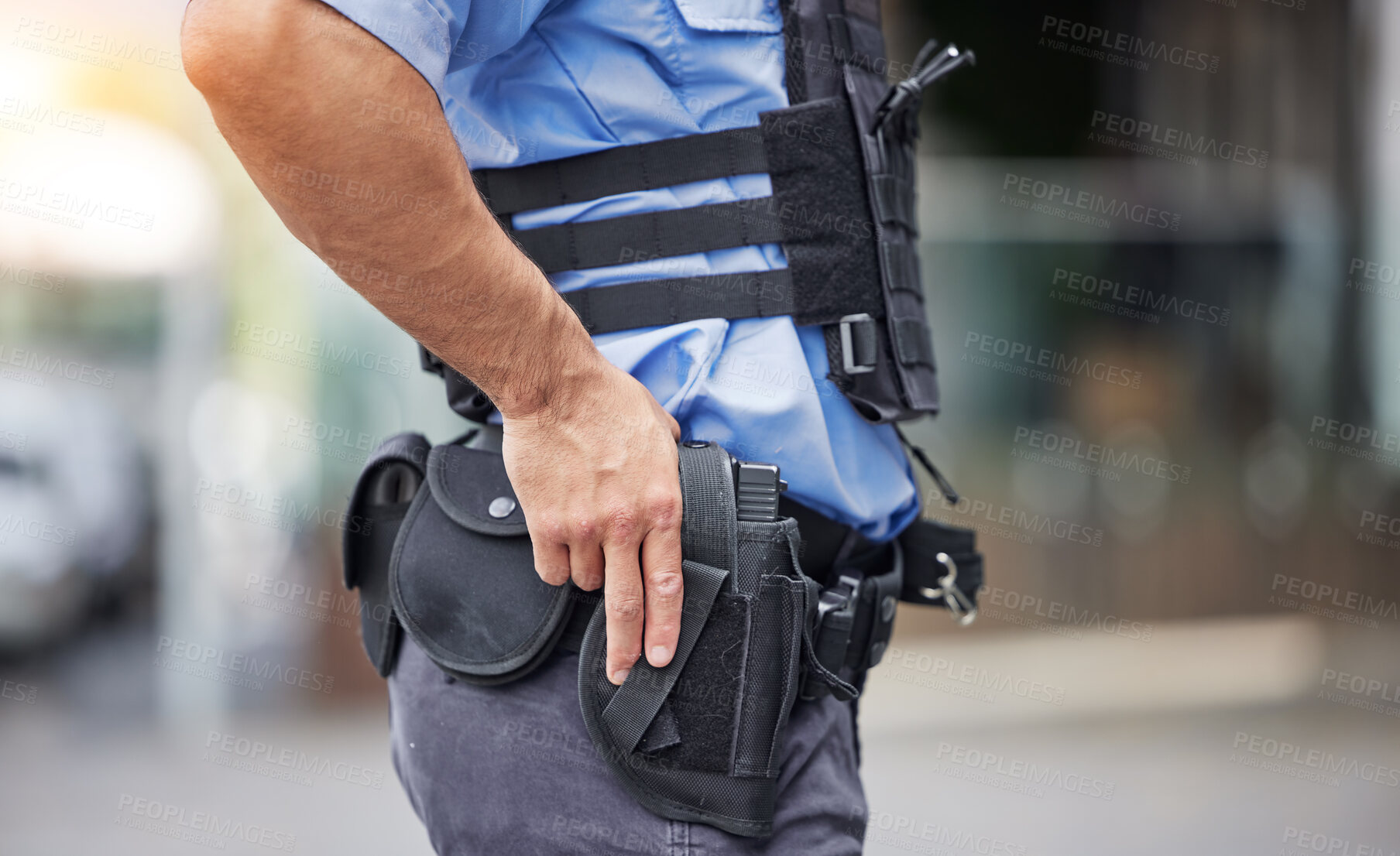 Buy stock photo Gun, uniform and police in the city for crime, security and outdoor justice in the street. Law, safety and a closeup of a man with a weapon in town for legal services, criminal or protection