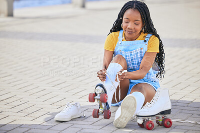 Roller skating, tie and safety with a black woman by the sea, on the promenade for training or recreation. Beach, sports and a young female teenager tying skates on the coast by the ocean or water