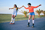 Holding hands, roller skates and friends on street for exercise, workout or training outdoor. Skating, happy people and girls together for sports on road to travel, journey and moving for fitness.