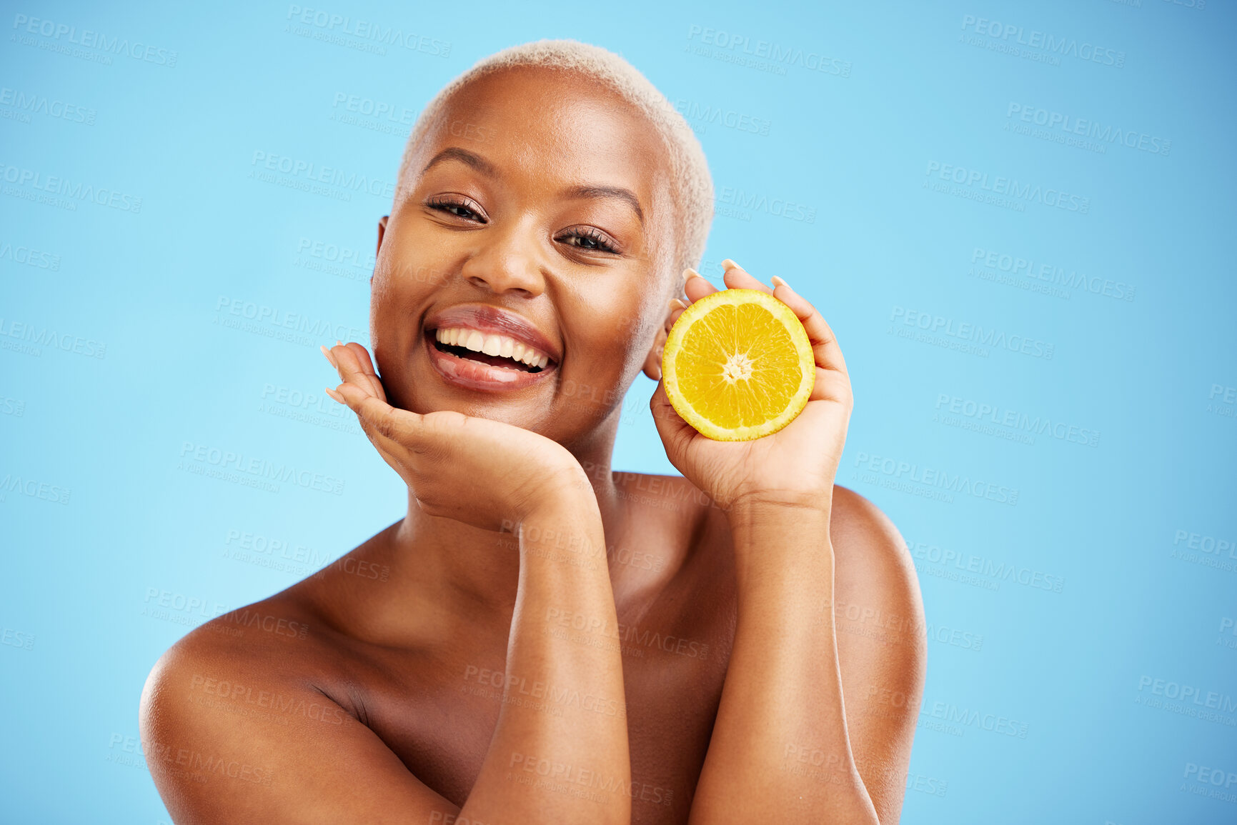 Buy stock photo Portrait, beauty and orange with a black woman in studio on a blue background for fruit nutrition. Smile, skincare or diet with a happy young female person holding food for natural health or wellness