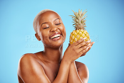 Buy stock photo Happy black woman, pineapple and diet for natural nutrition or health against a blue studio background. African female person smile in happiness holding organic fruit for vitamin, fiber or wellness