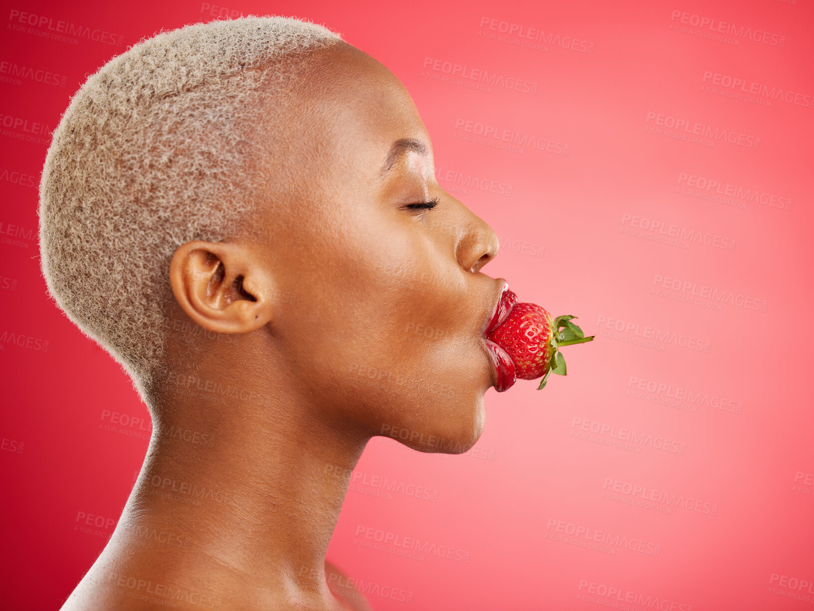 Buy stock photo Woman, strawberry and studio for beauty, profile and skincare for wellness, health and diet by red background. African model girl, healthy fruit and mouth with eyes closed, nutrition and cosmetics