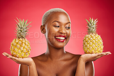 Buy stock photo Pineapple, beauty and face of a woman in studio for healthy food, diet or fruit. Black female model with makeup on red background for wellness glow, natural cosmetics and tropical or citrus skin care