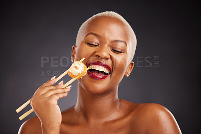 Buy stock photo Face, laugh and woman with sushi and chopsticks in studio for healthy eating, beauty or food. Black female model with makeup on a dark background for wellness glow, diet nutrition or funny seafood
