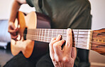 Hands, person and guitar for music, talent and skills in home studio. Closeup, musician and singer playing acoustic instrument for audio performance, artist and learning notes for sound production
