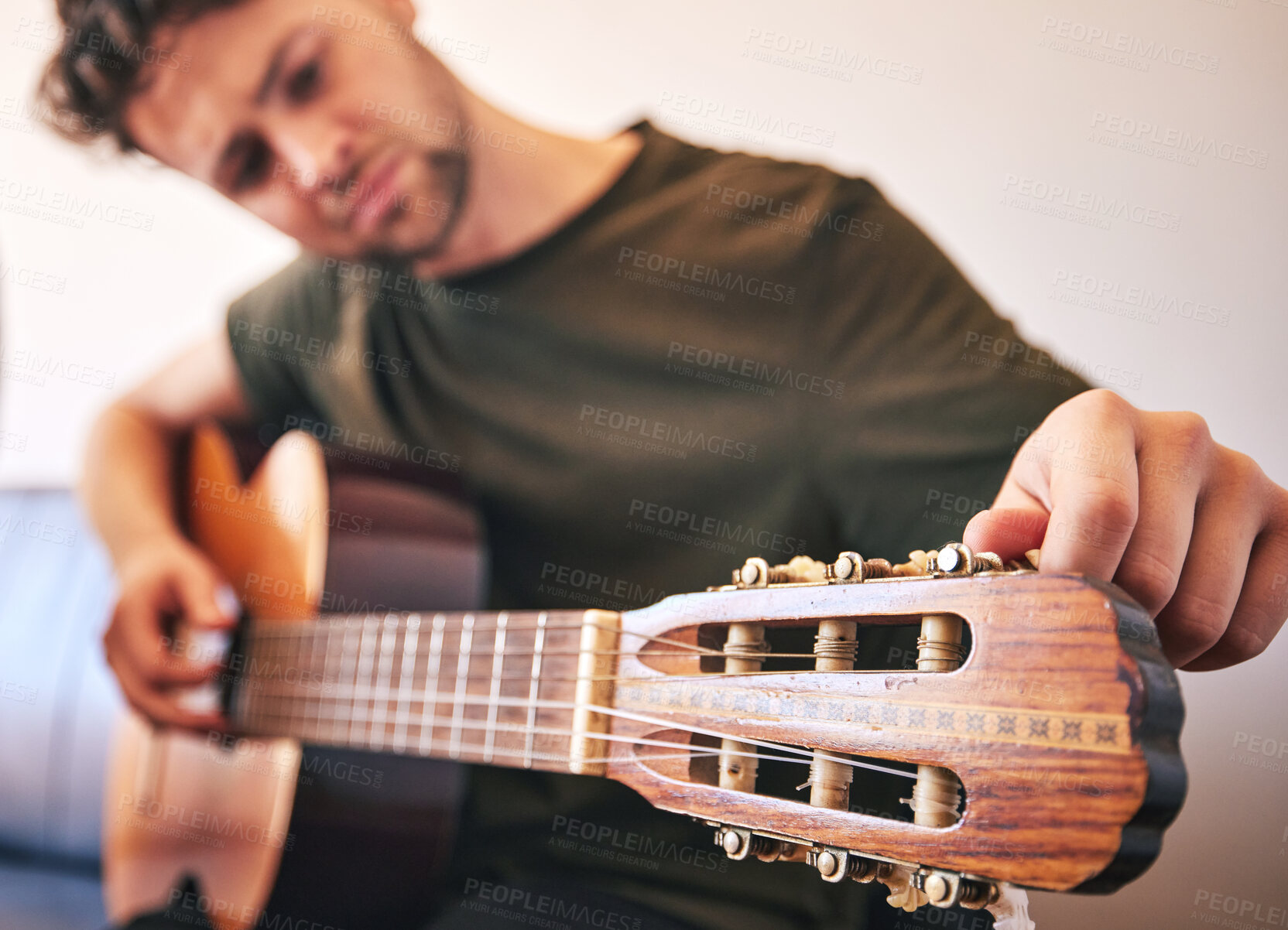 Buy stock photo Closeup, man and tuning guitar for music, talent and creative skill of sound production in home studio. Hands, musician and singer check notes of acoustic instrument for audio, performance and artist