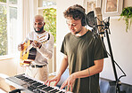 Piano, recording music and friends with guitar in home studio together. Electric keyboard, instrument and microphone of singer in collaboration for acoustic production with headphones of creative men